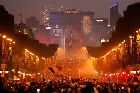 Soccer Football - World Cup - Final - France vs Croatia - Paris, France, July 15, 2018 - A giant picture of France's Antoine Griezmann is seen on the Arc de Triomphe as France fans celebrate on the Champs-Elysees Avenue after France win the Soccer World Cup final. REUTERS/Charles Platiau