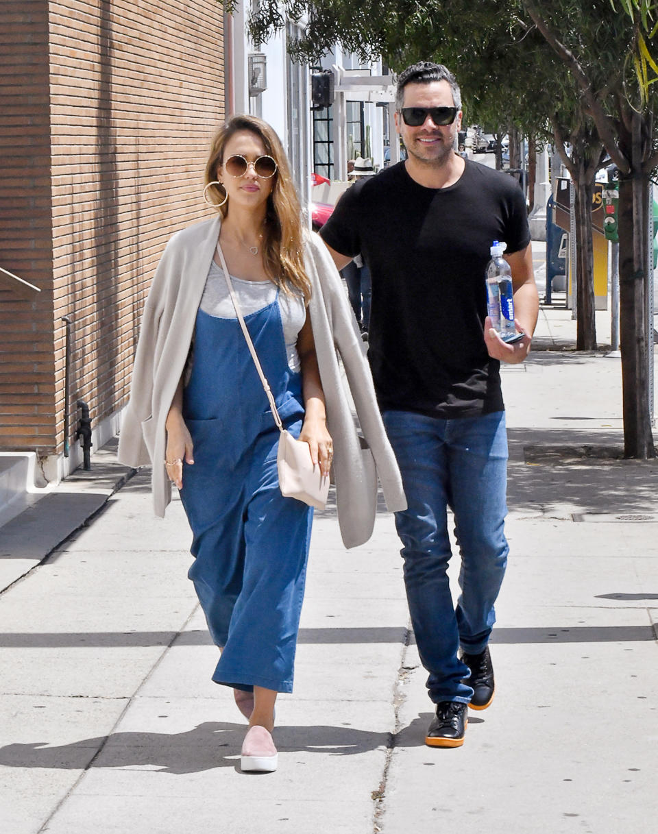 <p>Alba disguised her baby bump in a wide-leg cropped denim jumpsuit (shop a similar look <a rel="nofollow noopener" href="http://www.anrdoezrs.net/links/7799179/type/dlg/sid/IS,VID,ART,JessicaAlbaandHerHusbandGoforaStrollinMatchingDenimLooks,jonesi,201708,I/https://www.abercrombie.com/shop/us/p/denim-jumpsuit-10049763_02" target="_blank" data-ylk="slk:here;elm:context_link;itc:0;sec:content-canvas" class="link ">here</a>), layering the look with a gray tank and matching cardigan. The Honest co-founder gave her ensemble some characteristic flair with a blush-hued cross-body bag and pink platform sneakers (shop a similar look <a rel="nofollow noopener" href="https://click.linksynergy.com/fs-bin/click?id=93xLBvPhAeE&subid=0&offerid=365991.1&type=10&tmpid=2174&RD_PARM1=http%3A%2F%2Fwww.&RD_PARM2=saksfifthavenue.com%2Fmain%2FProductDetail.jsp%3F&RD_PARM3=PRODUCT%253C%253Eprd_id%3D845524446994901&u1=IS,VID,ART,JessicaAlbaandHerHusbandGoforaStrollinMatchingDenimLooks,jonesi,201708,I" target="_blank" data-ylk="slk:here;elm:context_link;itc:0;sec:content-canvas" class="link ">here</a>), topping the look off with a pair of round Elie Saab sunglasses ($982; <a rel="nofollow noopener" href="https://www.farfetch.com/shopping/women/elie-saab-round-framed-sunglasses-item-12002778.aspx" target="_blank" data-ylk="slk:farfetch.com;elm:context_link;itc:0;sec:content-canvas" class="link ">farfetch.com</a>) and oversize gold hoop earrings.</p>
