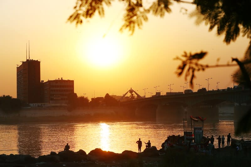 Iraqi demonstrators are seen on the bank of Tigris River during the ongoing anti-government protests, in Baghdad