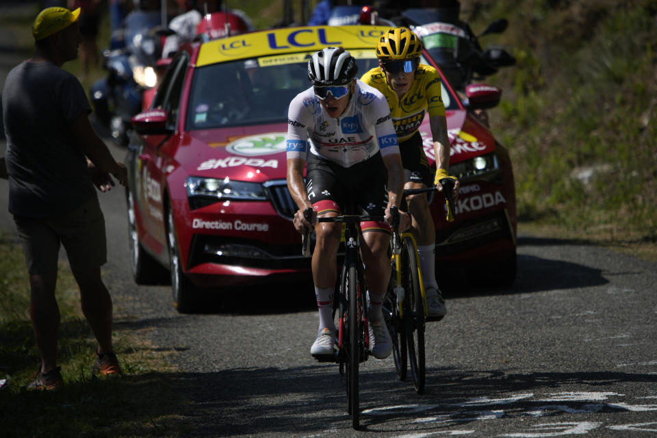 Slovenia's Tadej Pogacar, wearing the best young rider's white jersey, tries to break away from Denmark's Jonas Vingegaard, wearing the overall leader's yellow jersey, as they climb Col de Spandelles pass during the eighteenth stage of the Tour de France cycling race over 143.5 kilometers (89.2 miles) with start in Lourdes and finish in Hautacam, France, Thursday, July 21, 2022. (AP Photo/Daniel Cole)