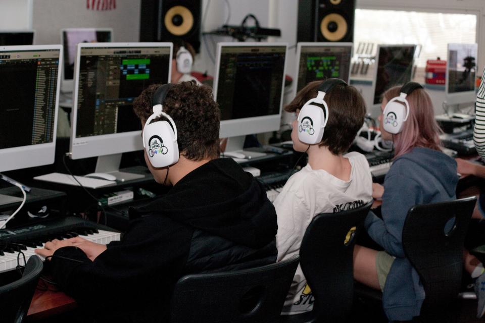 (Left to right) Current freshmen Jermey Myers and Leighton Tegland, as well as eighth grader Anna Woodham work on their projects for the Audio Engineering and Video Editing course at Harbor Springs.