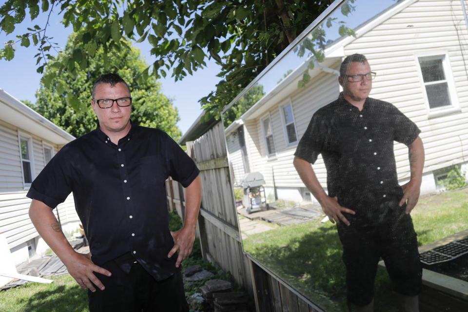 In a photo taken Friday, June 5, 2020, Scott Nichols, aka Amazing Scott, a local balloon artist, poses for The Associated Press in his backyard in Minneapolis. Nichols doesn't consider himself very political, but when George Floyd died, he felt compelled to join the protests which happened to be a few blocks from his home. He was arrested during one of the protests and spent 48 hours in jail before he was released. (AP Photo/Julio Cortez)