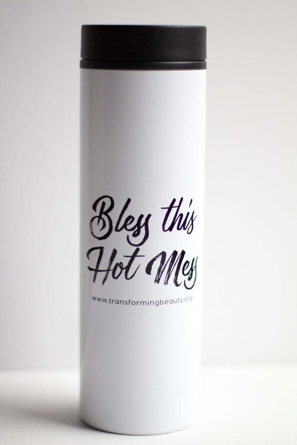 <a href="http://www.transformingbeautyshop.com/products/bless-this-hot-mess-travel-coffee-mug">Bless This Hot Mess Travel Coffee Mug, $12</a>