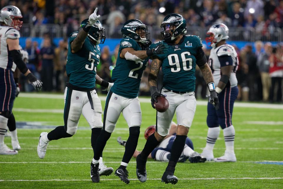 Derek Barnett, right, celebrates with his teammates after picking a fumble made by Tom Brady late in the 4th quarter Sunday at US Bank Stadium.