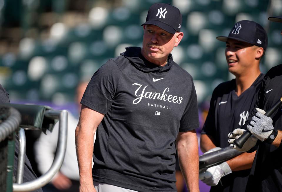 New York Yankees hitting coach Sean Casey watches players warm up for a baseball game against the Colorado Rockies on Friday, July 14, 2023, in Denver. (AP Photo/David Zalubowski)