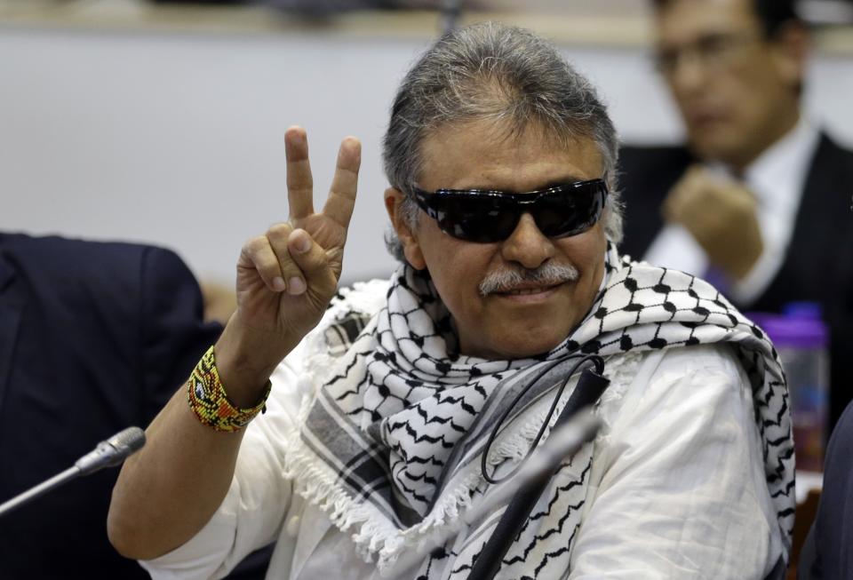 FILE - In this June 12, 2019 file photo, former FARC rebel Seuxis Hernandez, also known as Jesus Santrich, flashes a victory sign at journalists as he attends a session of the Chamber of Representatives at the Colombian congress in Bogota, Colombia. The rebel leader who abandoned a 2016 peace deal with Colombia’s government and had been at large for three years was killed in Venezuela on Monday, May 18, 2021, according to a statement published by his new armed movement. (AP Photo/Fernando Vergara, File)