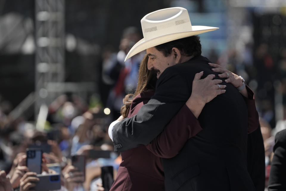 Former President Manuel Zelaya, who was ousted by a military coup in 2009, hugs his wife President-elect Xiomara Castro as they arrive for her inauguration as Honduras' first female president in Tegucigalpa, Honduras, Thursday, Jan. 27, 2022. (AP Photo/Moises Castillo)