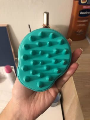 A scalp massaging shampoo brush