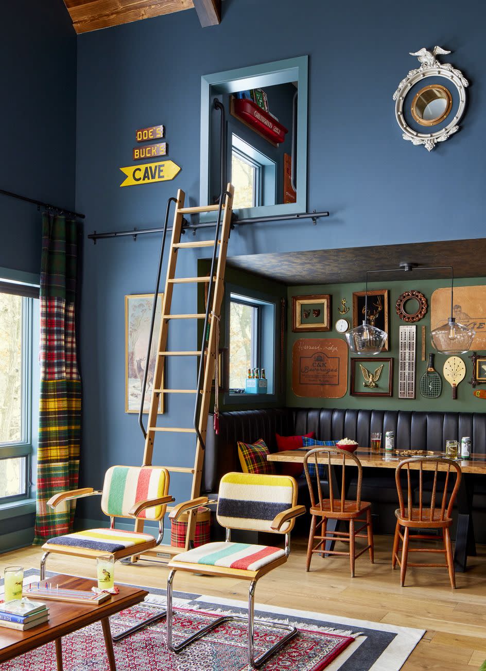 blue living room with vaulted ceilings and a ladder to a bunk room