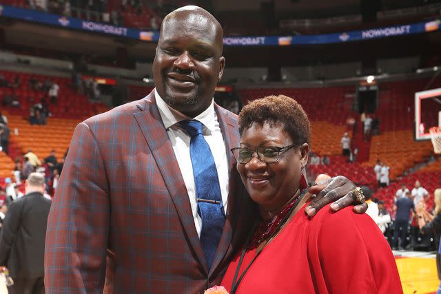 <p>Joe Murphy/NBAE/Getty</p> Shaquille O'Neal poses with his mother Lucille O'Neal before being honored at his number retirement ceremony on December 22, 2016.