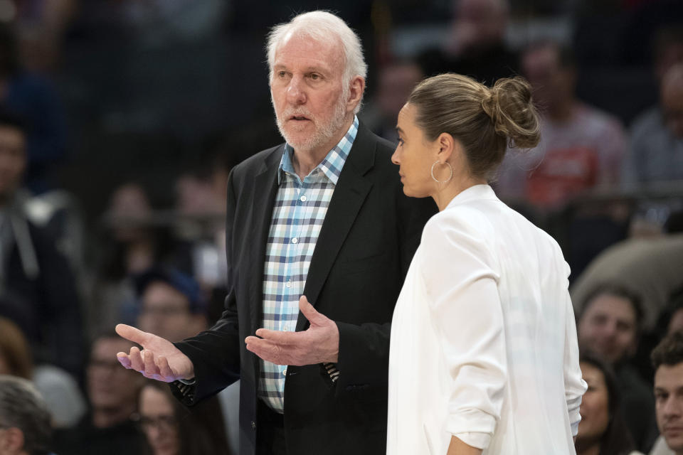 Gregg Popovich talks to Becky Hammon during a 2019 game.