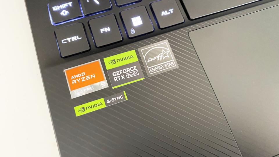 Asus ROG Flow X13 laptop stickers close up on a white desk