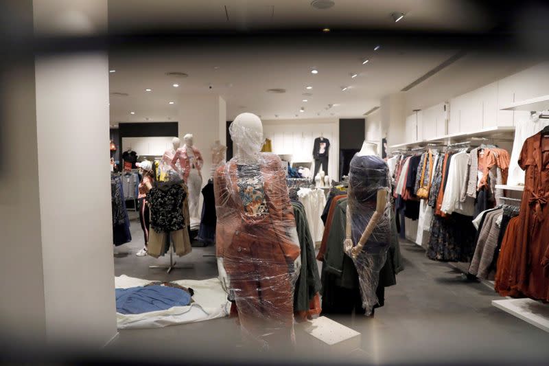 A mannequin is seen covered in plastic inside a shop at a mall ahead of its reopening during an extended nationwide lockdown to slow down the spread of the coronavirus disease (COVID-19), in New Delhi