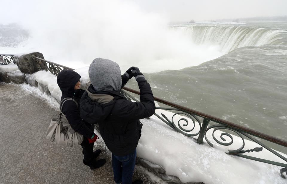 Visitors take pictures overlooking Niagara Falls