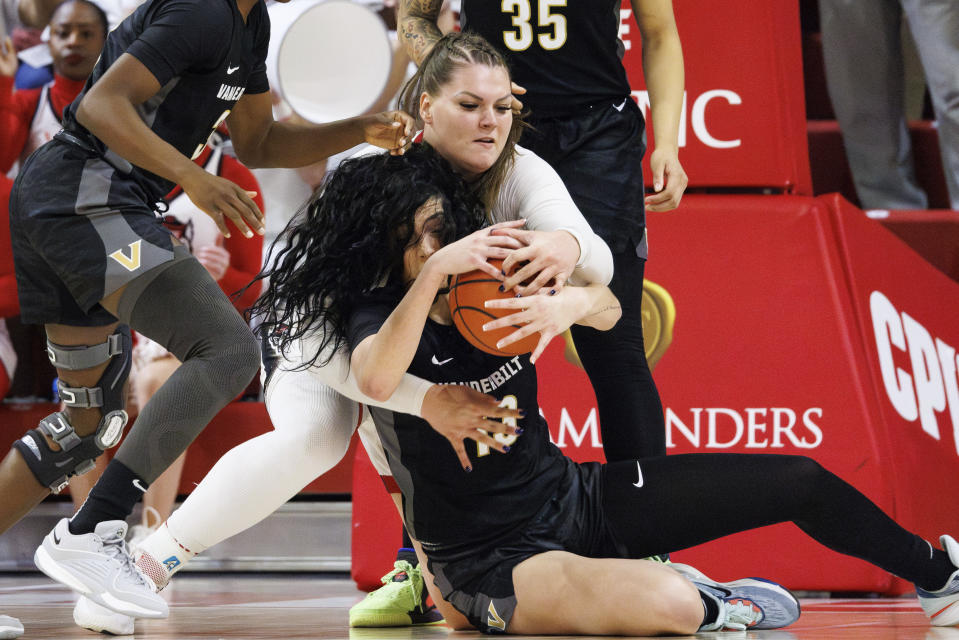 North Carolina State's River Baldwin, left, battles with Vanderbilt's Justine Pissott (13) for a loose ball during the first half of an NCAA college basketball game in Raleigh, N.C., Wednesday, Nov. 29, 2023. (AP Photo/Ben McKeown)