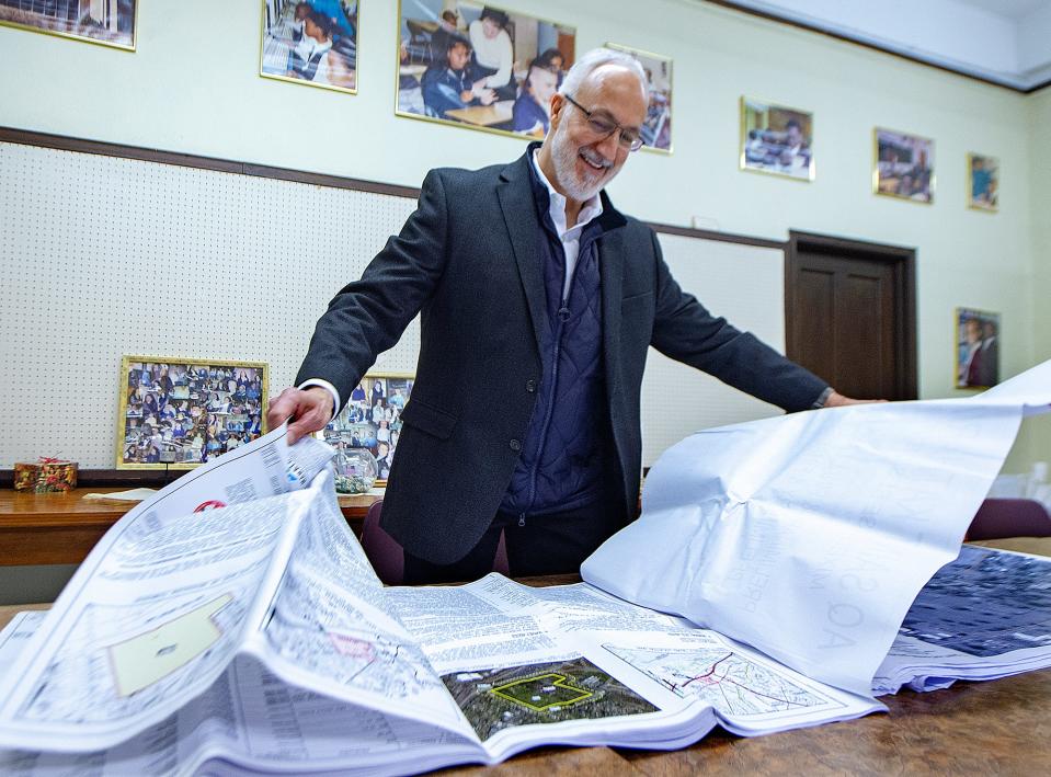 Developer Len Poncia reviews blue prints for the redevelopment of the former Drexel shrine on Bristol Pike, in Bensalem, on Tuesday, Feb. 15, 2022..