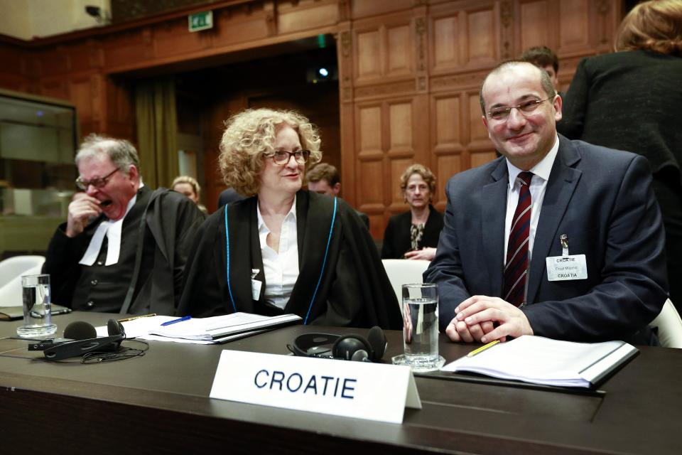 Members of the Croatian delegation, Minister Orsat Miljenic, right, Vesna Crnic-Grotic, center, and James Crawford, left, during the start of public hearings at the International Court of Justice (ICJ) in The Hague, Netherlands, Monday, March 3, 2014. Croatia is accusing Serbia of genocide during fighting in the early 1990's as the former Yugoslavia shattered in spasms of ethnic violence, in a case at the United Nations' highest court that highlights lingering animosity in the region. Croatia is asking the ICJ to declare that Serbia breached the 1948 Genocide Convention when forces from the former Federal Republic of Yugoslavia attempted to drive Croats out of large swaths of the country after Zagreb declared independence in 1991. (AP Photo/Jiri Buller)