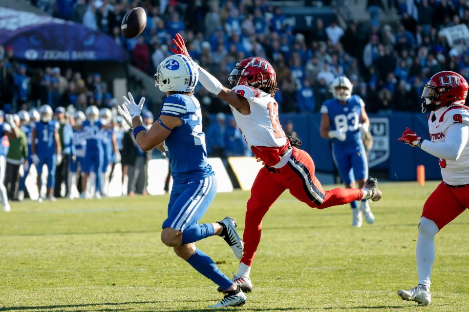 BYU Cougars wide receiver Chase Roberts (27) makes a catch under pressure from Utah Tech cornerback Antonio Mayes (12) and runs the ball in for a touchdown to put the Cougars up 14-13 after the PAT during the game at LaVell Edwards Stadium in Provo on Saturday, Nov. 19, 2022.