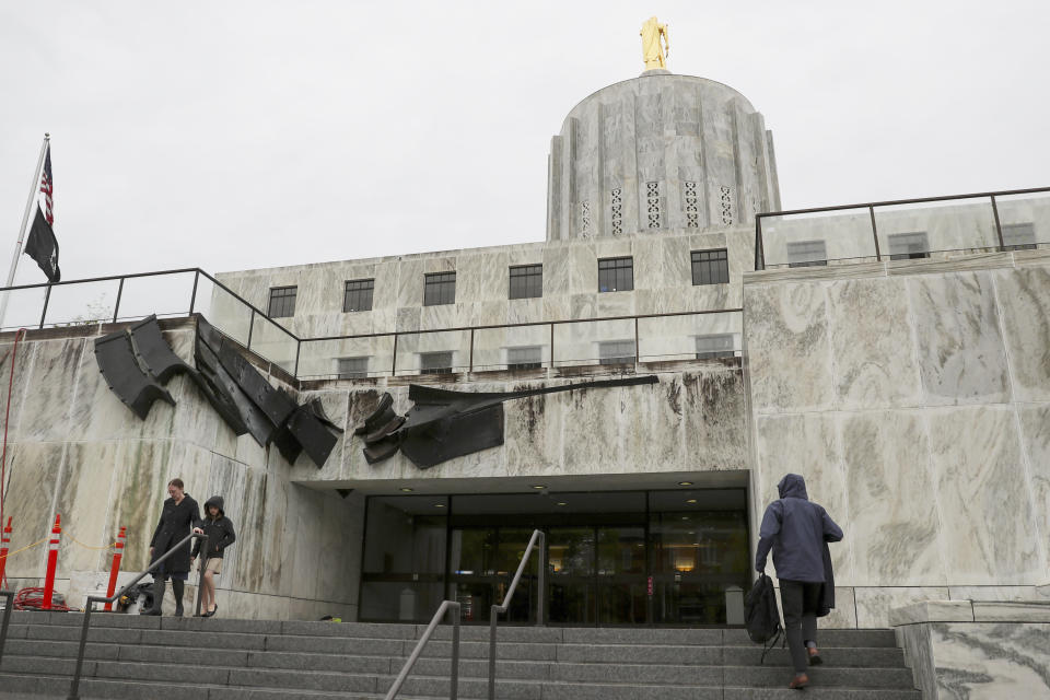 People walk in and out of the Oregon State Capitol in Salem, Ore., Thursday, May 4, 2023. Republican members of the Oregon Senate on Thursday extended their boycott of Senate proceedings into a second day, delaying action by the majority Democrats on bills on gun safety, abortion rights and gender-affirming health care. (AP Photo/Amanda Loman)