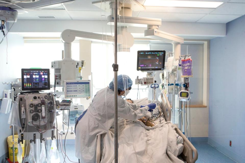 A nurse tends to a patient at the Bluewater Health Hospital in Sarnia, Ont., on Tuesday, Jan. 25, 2022. Ontario's fiscal watchdog says the province's health-care plans will be short 33,000 nurses and personal support workers by 2028. 