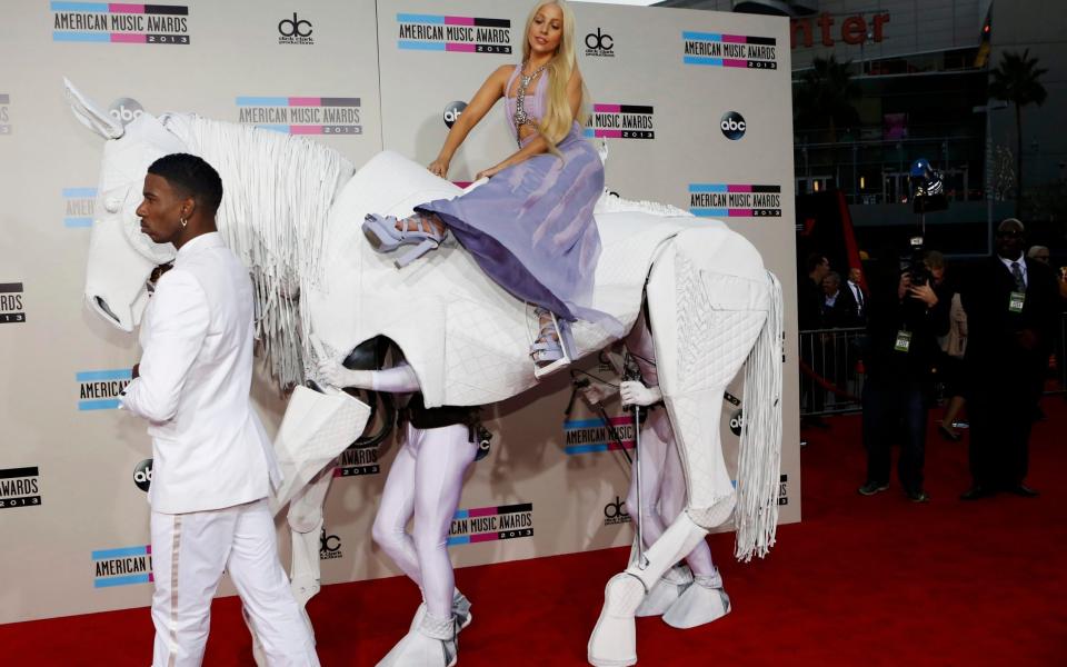 Lady Gaga arrives on a mechanical horse to the 41st American Music Awards in 2013 - Reuters