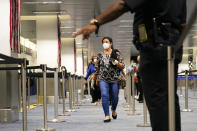 International passengers arrive at Miami international Airport where they are screened by U.S. Customs and Border Protection (CBP) using facial biometrics to automate manual document checks required for admission into the U.S. Friday, Nov. 20, 2020, in Miami. Miami International Airport is the latest airport to provide Simplified Arrival airport-wide. (AP Photo/Lynne Sladky)