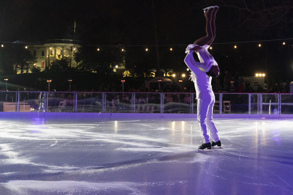 David Faria Oliviera and Carlina Justine Ramirez, an Adagio Pairs Team, perform during the unveiling of the White House Holiday Ice Rink, located at the south panel of the South Lawn of the White House, Wednesday, Nov. 29, 2023, in Washington. (AP Photo/Jacquelyn Martin)