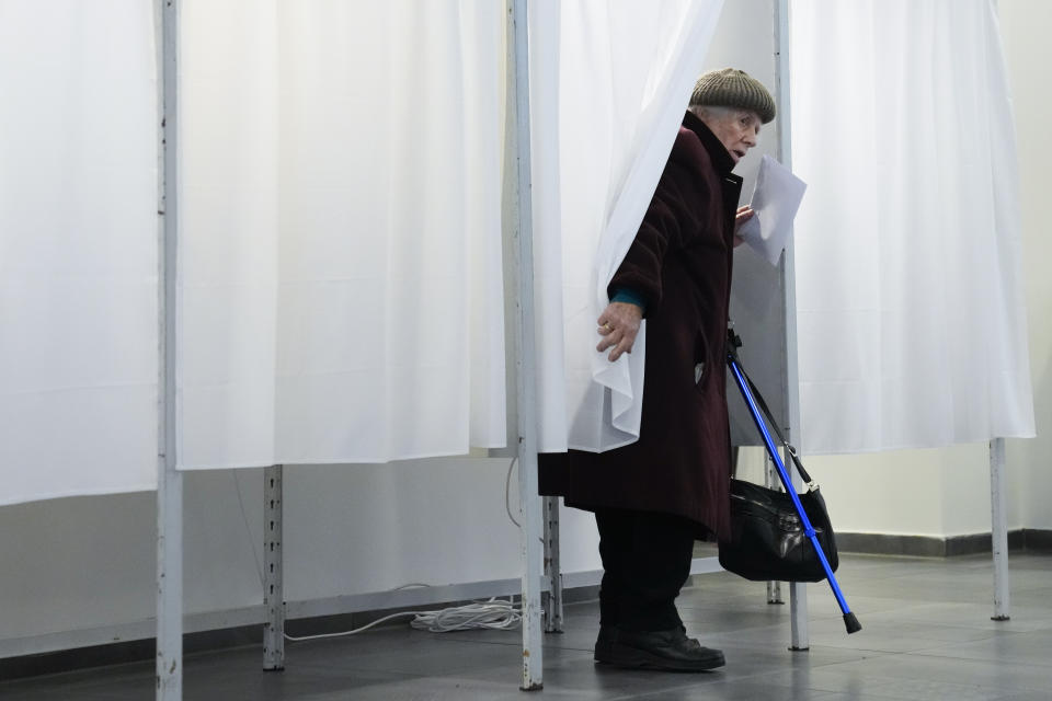 A woman votes in Budapest, Hungary, Sunday, April 3, 2022. Hungary's nationalist prime minister, Viktor Orban, seeks a fourth straight term in office, a coalition of opposition parties are framing the election as a referendum on Hungary's future in the West. (AP Photo/Petr David Josek)