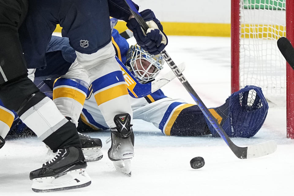 St. Louis Blues goaltender Jordan Binnington dives for the puck during the second period of an NHL hockey game against the Los Angeles Kings Saturday, March 4, 2023, in Los Angeles. (AP Photo/Mark J. Terrill)