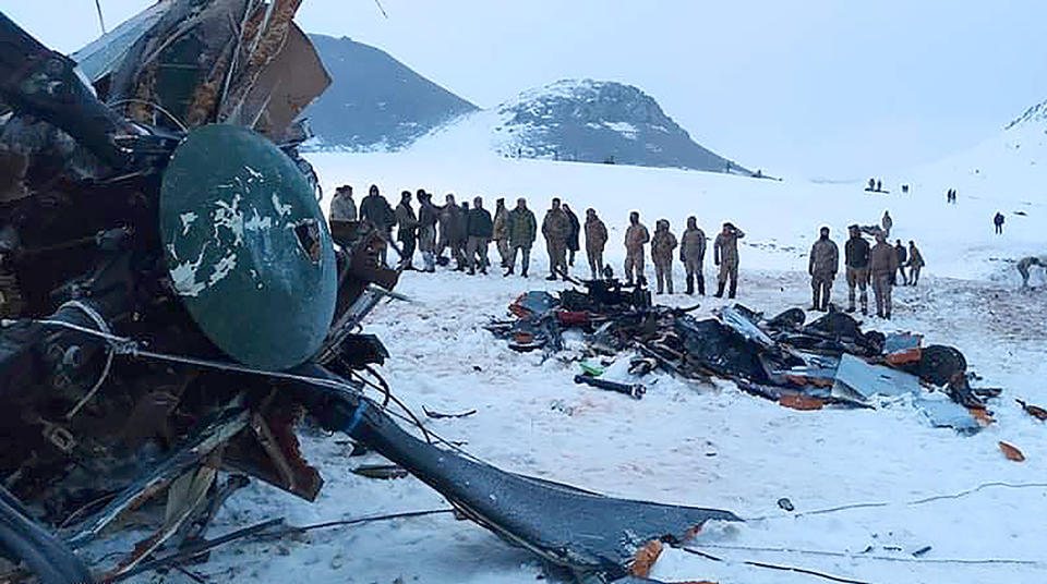 Soldiers and rescue workers stand around the wreckage after an army helicopter crashed in Bitlis, eastern Turkey, Thursday March 4, 2021. Turkey’s Defense Ministry says a military helicopter has crashed, killing several soldiers on board and injuring others. News reports said the victims included an army corps commander. The ministry described the crash as an accident, but it wasn’t immediately known what caused it. (IHA via AP )