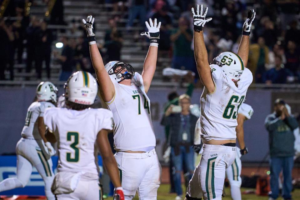 Oct 28, 2022; Chandler, AZ, USA; Basha Bears offensive linebackers Dylan Post (74) and James Durand (63) celebrate the Bearsâ€™ game winning touchdown in the closing minutes of the fourth quarter against the Chandler Wolves at Austin Field in Chandler on Friday, Oct. 28, 2022. Mandatory Credit: Alex Gould/The Republic