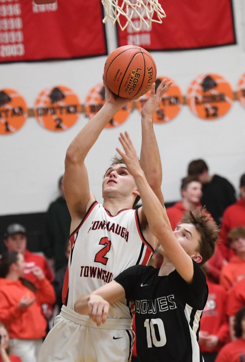 Conemaugh Township's Jon Updyke goes to the basket over West Shamokin's Jude Olinger (10) during a Heritage Conference boys basketball semifinal, Feb. 5, in Davidsville.