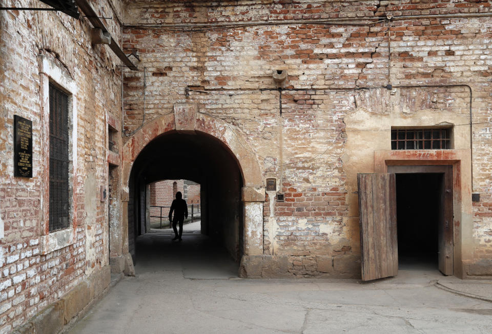 Visitor walks at through the former Nazi concentration camp in Terezin, Czech Republic, Thursday, Jan. 24, 2019. A unique collection of some 4,500 drawings by children who were interned at the Theresienstadt concentration camp during the Holocaust now displayed in the Pinkas Synagogue, still attracts attention even after 75 years since their creation. The drawings depict the everyday life as well hopes and dreams of returning home. (AP Photo/Petr David Josek)