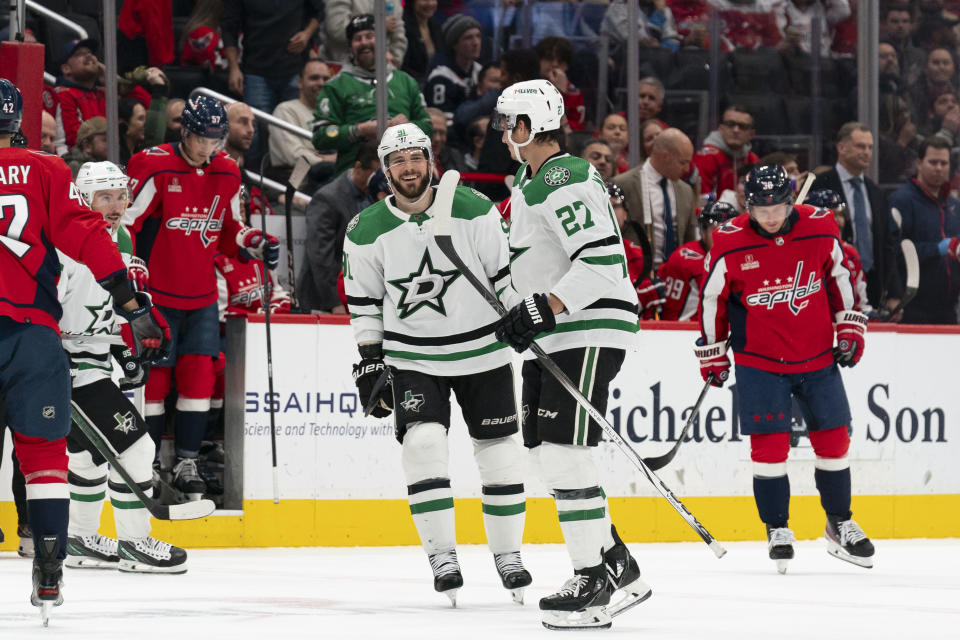 Dallas Stars center Tyler Seguin (91) celebrates with left wing Mason Marchment (27) after Marchment scored during the second period of an NHL hockey game, Thursday, Dec. 7, 2023, in Washington. (AP Photo/Stephanie Scarbrough)