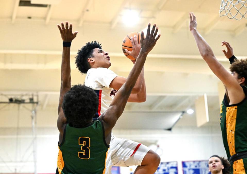 Modesto Christian’s Gavin Sykes drives to the hoop past Vanden’s Josh Neal (3) during the Holiday Hoop Classic championship game at Modesto Christian High School in Salida, Calif., Saturday, Dec. 30, 2023. Modesto Christian won 68-61.