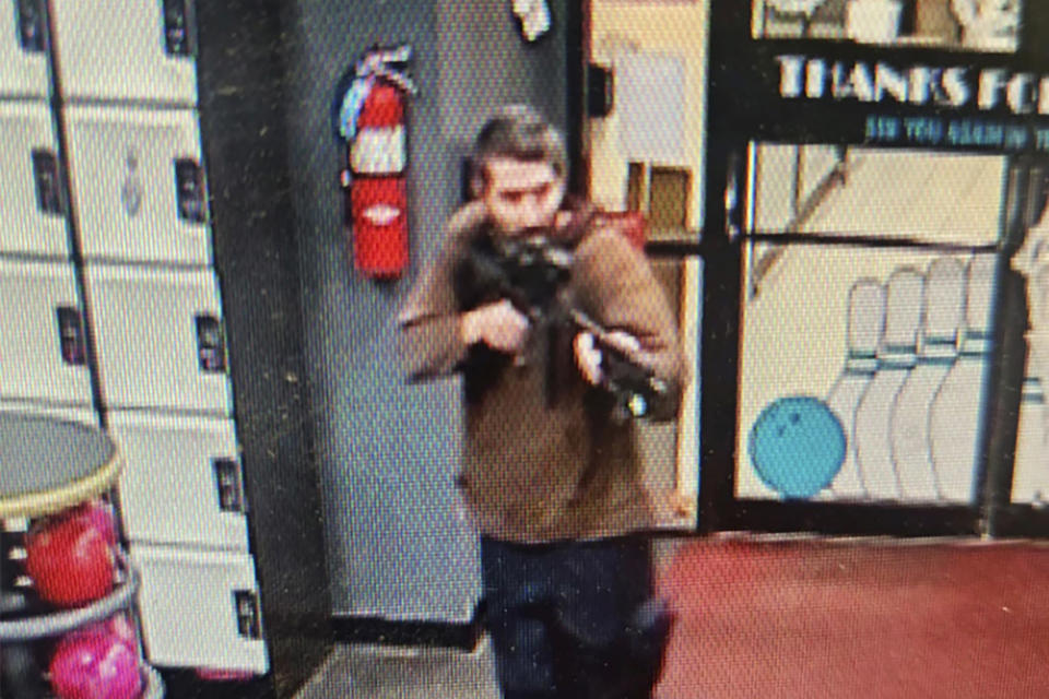 In this image from video released by the Androscoggin County Sheriff's Office, a gunman enters Just-In-Time Recreation in Lewiston, Maine, on Wednesday, Oct. 25, 2023. Maine State Police ordered residents in the state's second-largest city to shelter in place as the suspect remains at large as of Thursday evening. (Androscoggin County Sheriff's Office via AP)