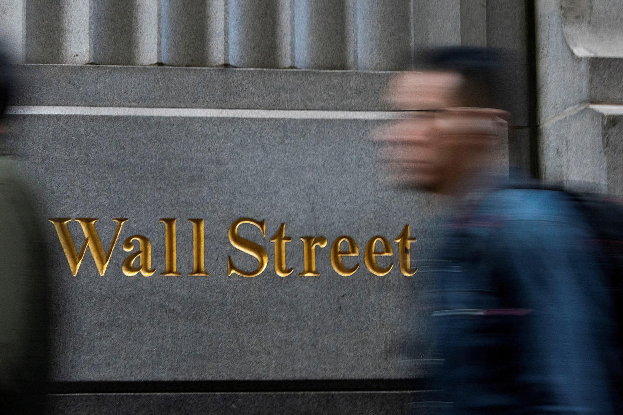 People walk around the New York Stock Exchange in New York.