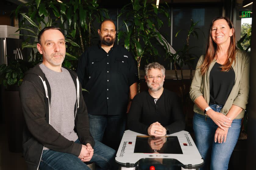 Los Angeles, CA - October 24: Eric Williams, Matt Sophos, Cory Barlog and Meghan Morgan Juinio, from left to right, pose for a portrait at their Santa Monica Studio on Monday, Oct. 24, 2022 in Los Angeles, CA. They are some of the main creatives and executives at the studio that is known for making the "God of War' games. (Dania Maxwell / Los Angeles Times)