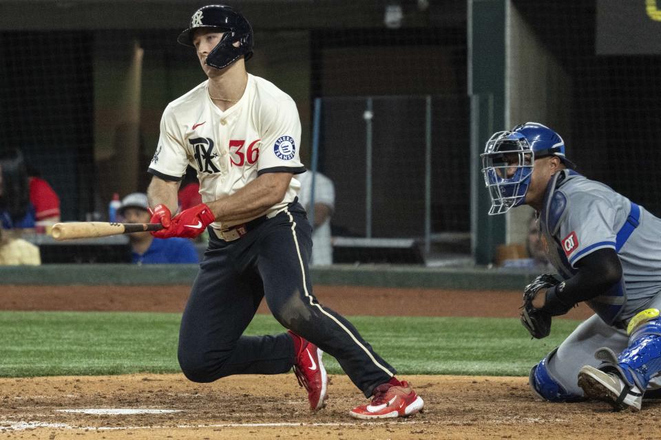 Texas Rangers' Wyatt Langford (36) watches an RBI single off of Kansas City Royals relief pitcher John Schreiber during the sixth inning of a baseball game Friday, June 21, 2024, in Arlington, Texas. (AP Photo/Jeffrey McWhorter)