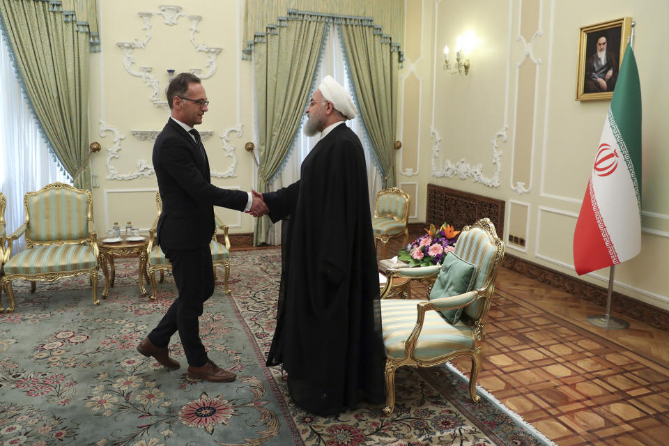 In this photo released by the official website of the office of the Iranian Presidency, President Hassan Rouhani, right, welcomes German Foreign Minister Heiko Maas for their meeting, in Tehran, Iran, Monday, June 10, 2019. (Iranian Presidency Office via AP)