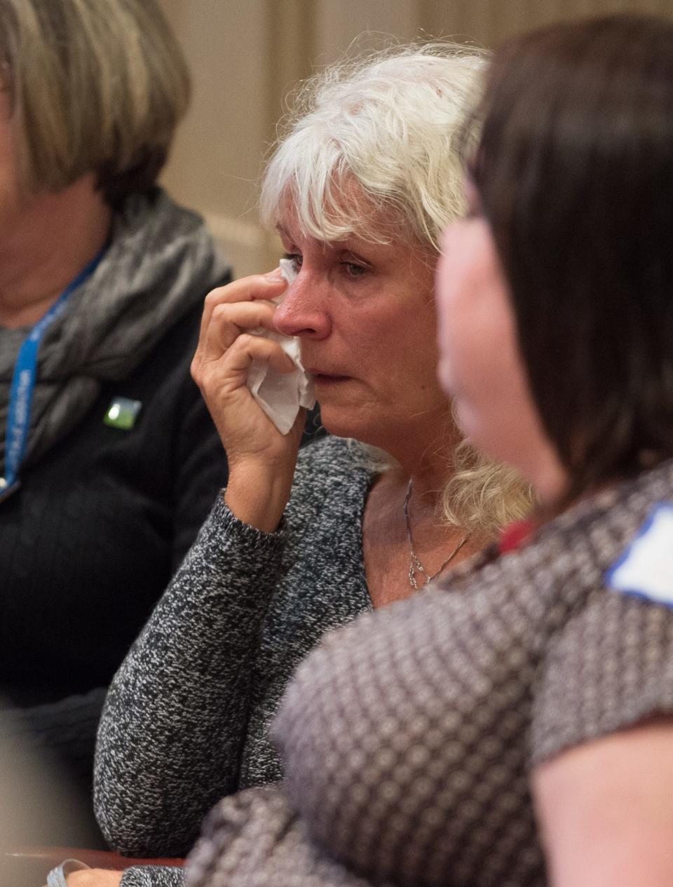 MaryBeth Cichocki wipes tears from her eyes during then-Delaware Attorney General Matt Denn's announcement of legislation in 2017 to expand substance abuse treatment and reduce over-prescription of opioids during a press conference at Legislative Hall in Dover.