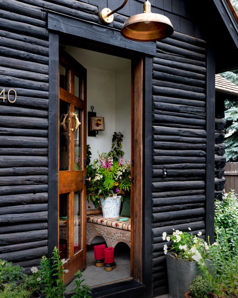 emily janak teton mountains, jackson hole, wyoming home entry sealing the exterior of her 1936 log cabin black allowed designer emily janak to match it to a new addition and make it look as cohesive as possible sealant x 100 natural seal wood protective coating in weathered creosote by abr products copper light aq lighting trout door knocker adams mack