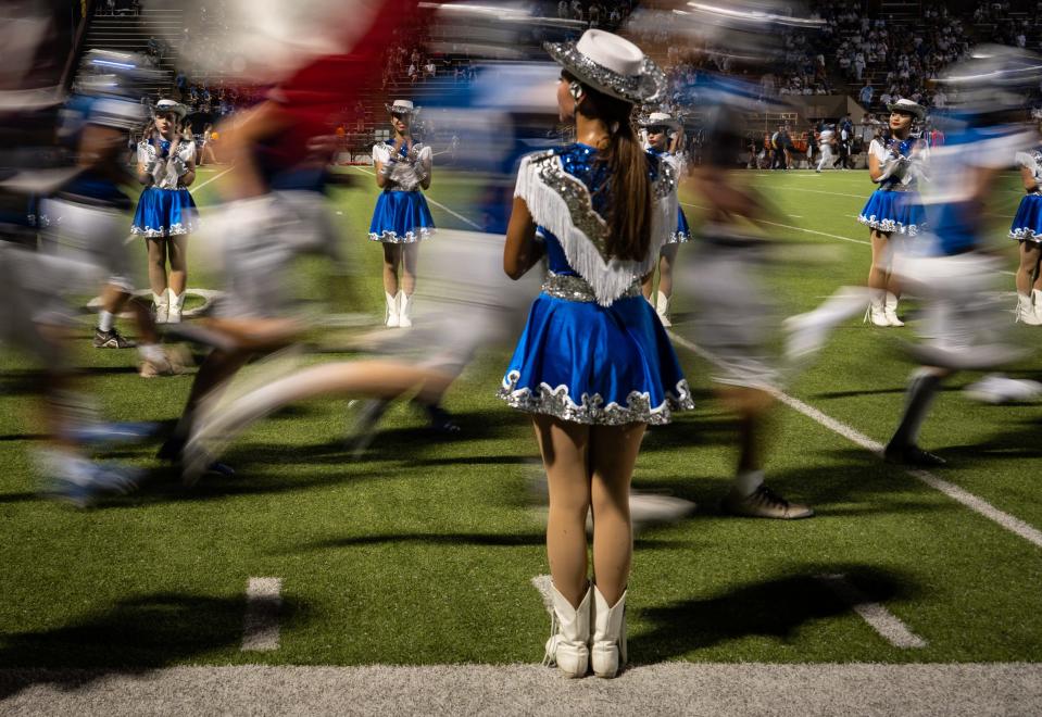 The McCallum Blue Brigade stands at attention as the football team returns to the field after halftime at House Park during Thursday night's season opener against Anderson. Central Texas football kicks off across the board on Friday night.