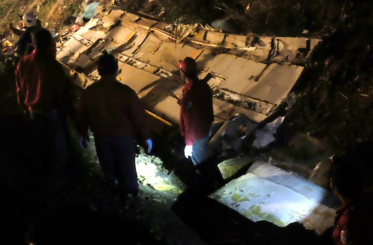 Rescuers search the wreckage of a bus for survivors after an accident on a highway in Taipei on February 13, 2017