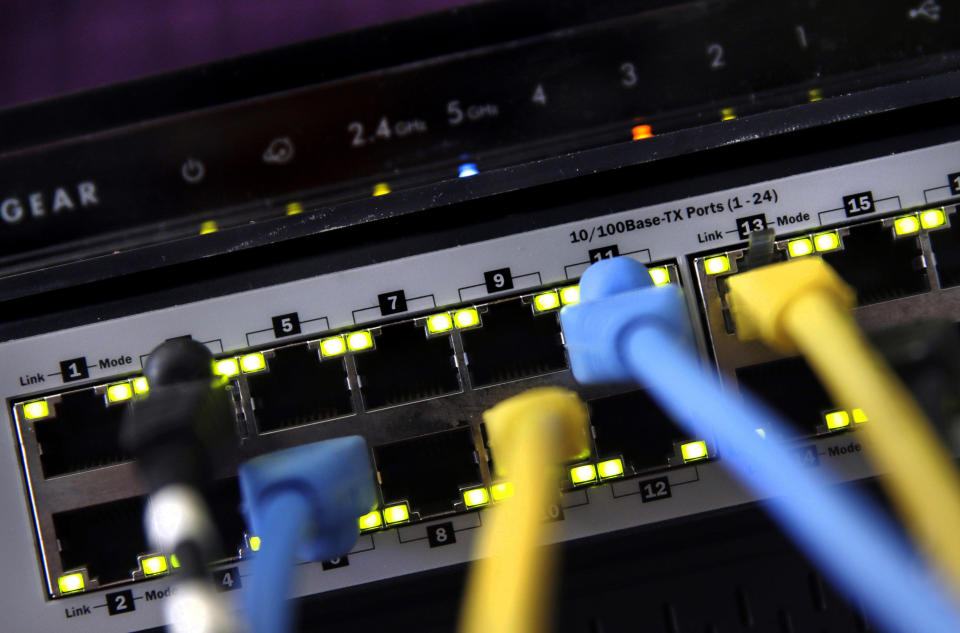 FILE - In this June 19, 2018, file photo, a router and internet switch are displayed in East Derry, N.H. The FBI said cyberattacks have become common at schools, which are attractive targets because they hold sensitive data and provide critical public services. Malicious use of the data could lead to bullying, tracking and identity theft, the agency said. (AP Photo/Charles Krupa, File)