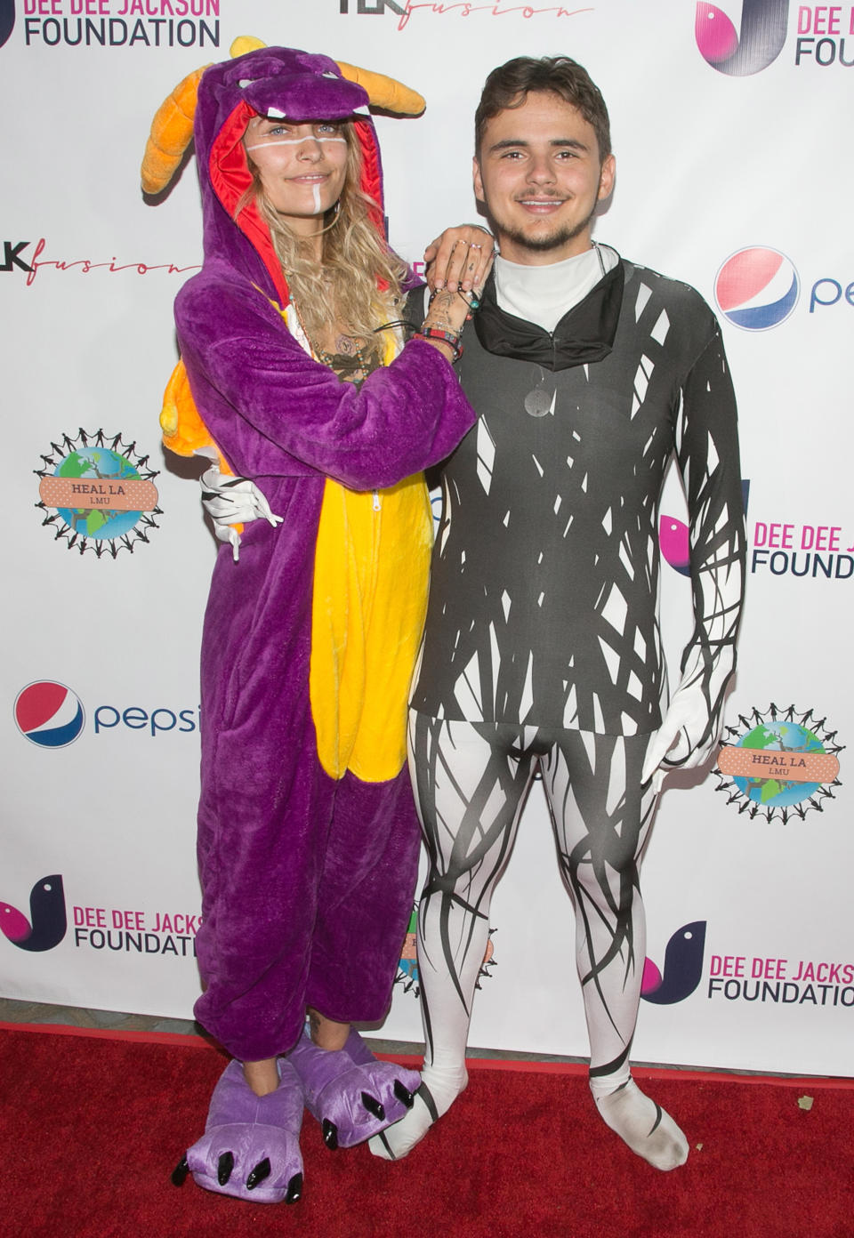 <p>Michael Jackson’s children, Prince and Paris, hung together for a good cause at a charity costume party, which was at the Jackson family estate in Encino, Calif. The brother-sister duo kept it casual in some festive onesies. (Photo: Getty Images) </p>