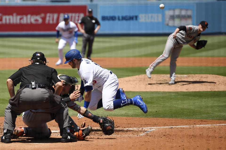 Los Angeles Dodgers' Max Muncy, center, is hit by a pitch thrown by San Francisco Giants starting pitcher Logan Webb during the second inning of a baseball game Saturday, July 25, 2020, in Los Angeles. (AP Photo/Mark J. Terrill)