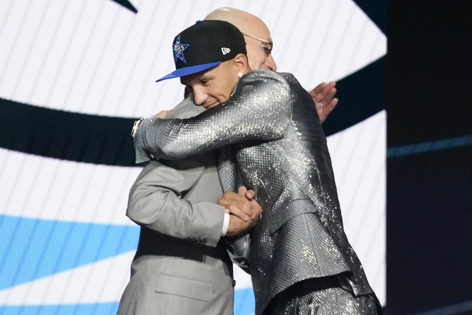 Jalen Suggs hugs NBA Commissioner Adam Silver after being selected fifth overall by the Orlando Magic during the NBA basketball draft, Thursday, July 29, 2021, in New York. (AP Photo/Corey Sipkin)
