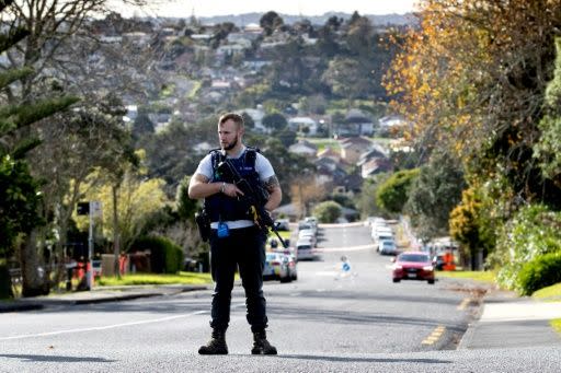 An officer stands on guard with his gun drawn. Source: AFP