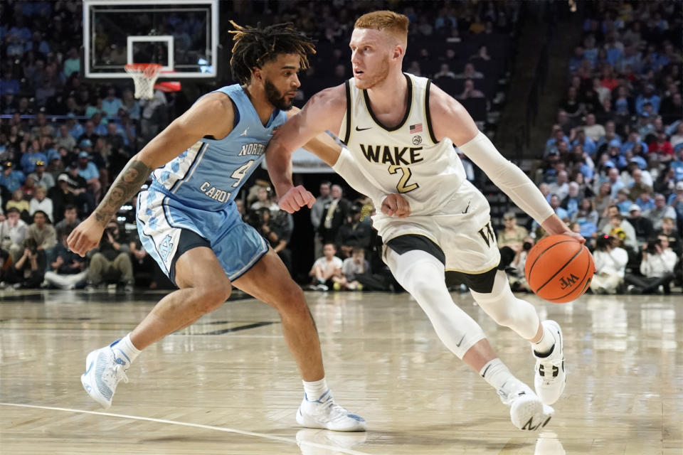 Wake Forest guard Cameron Hildreth (2) drives against North Carolina guard R.J. Davis (4) during the first half of an NCAA college basketball game in Winston-Salem, N.C., Tuesday, Feb. 7, 2023. (AP Photo/Chuck Burton)